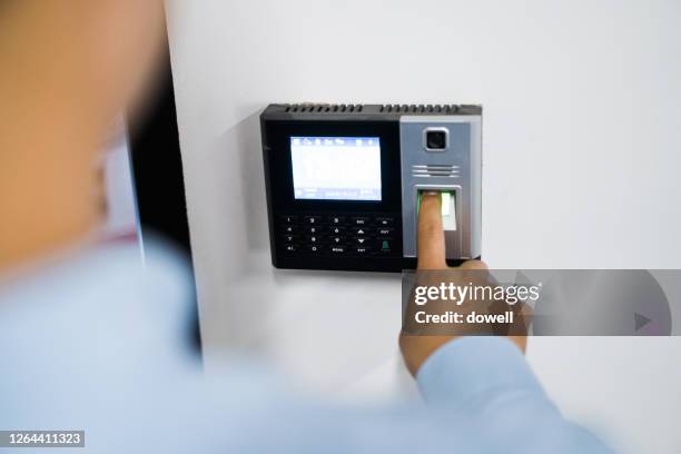 man touches fingerprint in office - fingerabdruck scanner stock-fotos und bilder