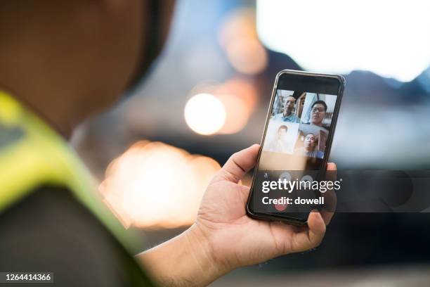 old man technician uses mobile phone on video call - work video call stock pictures, royalty-free photos & images