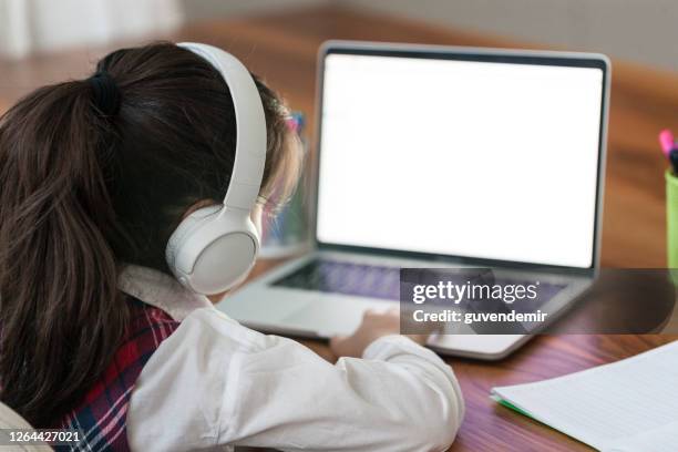 little girl using laptop computer - computer screen over shoulder stock pictures, royalty-free photos & images