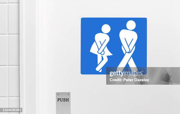 gender neutral toilet sign, legs crossed urgent need to urinate - restroom sign stock-fotos und bilder