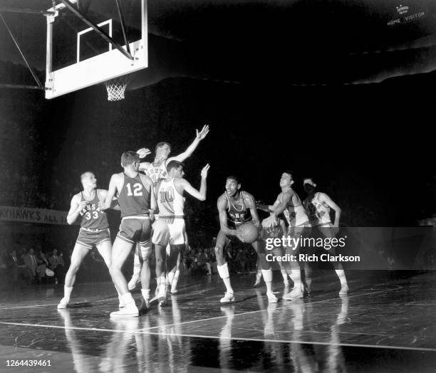 Wilt Chamberlain of the Kansas Jayhawks holds the ball in the paint against the North Carolina Tar Heels during the NCAA Final Four National...