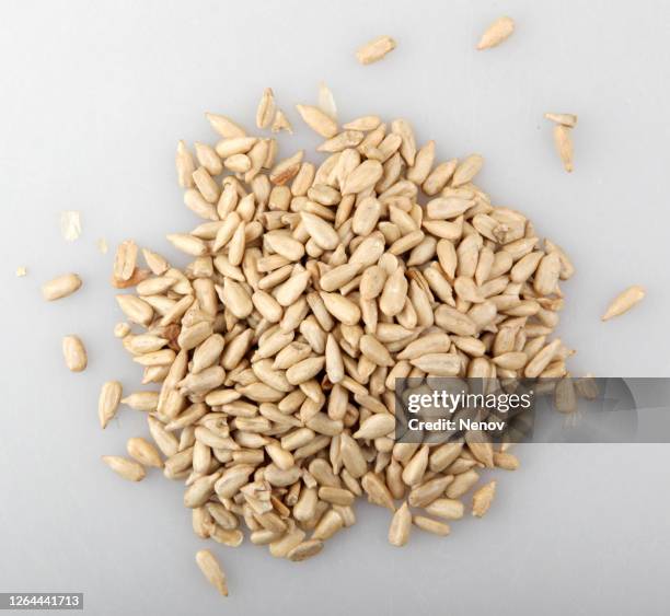 close-up of peeled sunflower seed isolated on white background - bird seed stockfoto's en -beelden