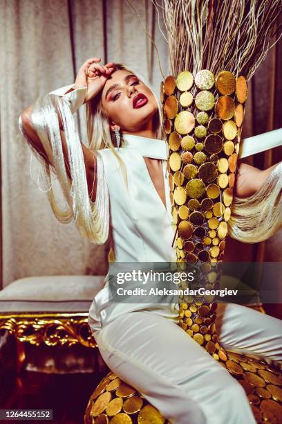 luxurious female and her golden vase - model gold dress stock pictures, royalty-free photos & images