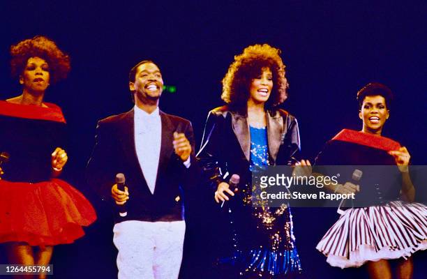 American R&B, Soul, Gospel, and Pop singer Whitney Houston at Wembley Arena, London, . With her are back up singers Gary Houston , Felicia Moss, and...