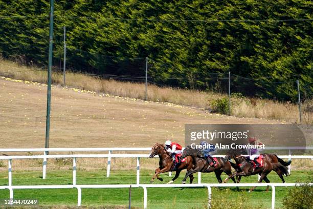 Martin Dwyer riding Perotto win The Oxshott Nursery at Sandown Park Racecourse on August 07, 2020 in Esher, England. Owners are allowed to attend if...
