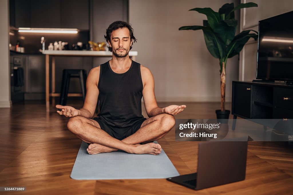 Man meditating in the living room