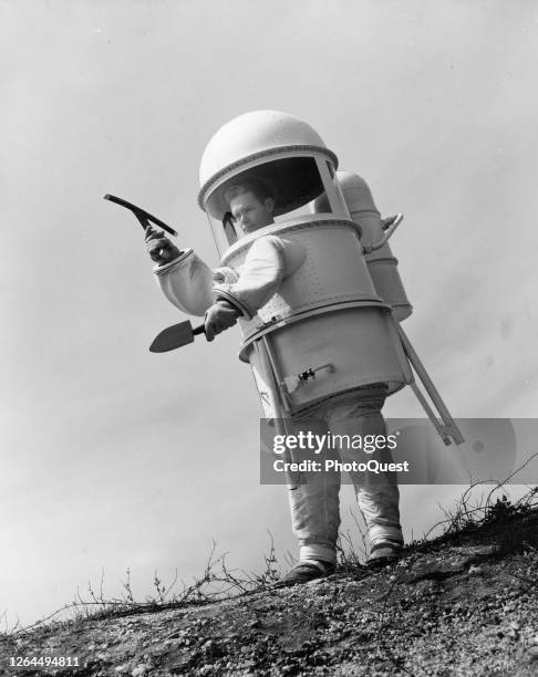 View of a prototype design for two-piece lunar exploration suit , Farmingdale, New York, 1960. The suit includes a tripod and built-in seat.
