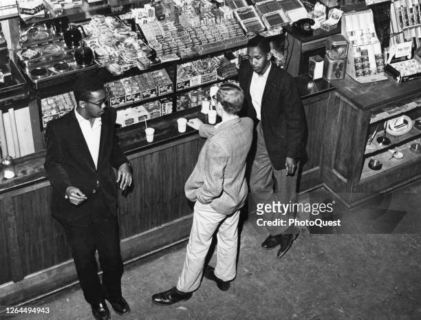 Elevated view of University of North Carolina integration pioneers LeRoy Frasier and his brother, Ralph Frasier , as they chat with an unidentified...