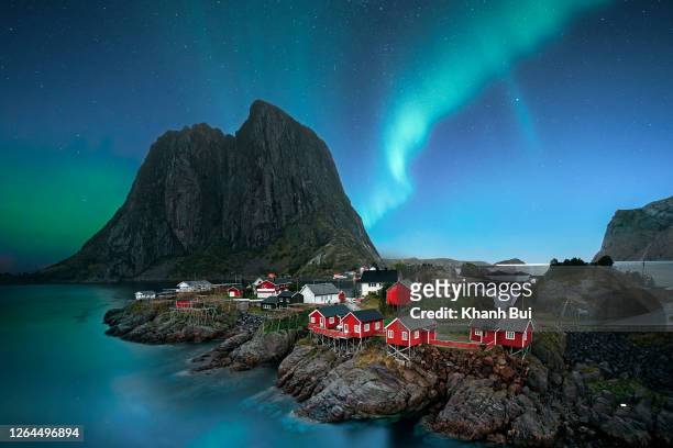 dawn in small viilage, lofoten and magic northern lights in sky - norvegia stock-fotos und bilder
