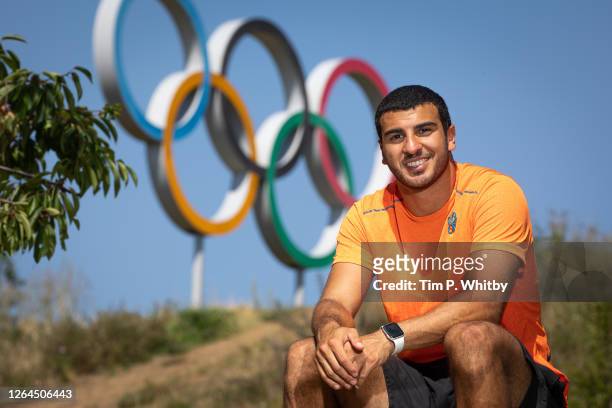 Athlete Adam Gemili poses for a photograph in front of the Olympic Rings as he takes part in an Alzheimer's Society memory walk, to honour his...