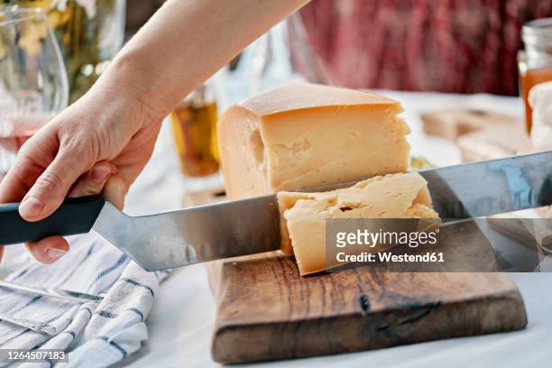 hands cutting cheese on wood - cheese stock pictures, royalty-free photos & images