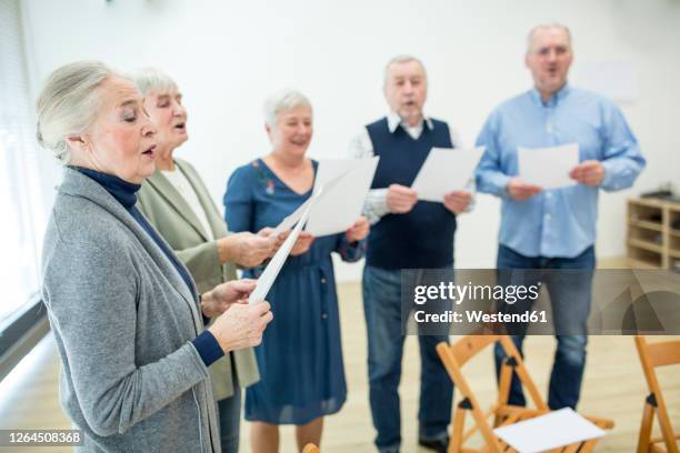 seniors in retirement home making music singing in choir - singing stock pictures, royalty-free photos & images