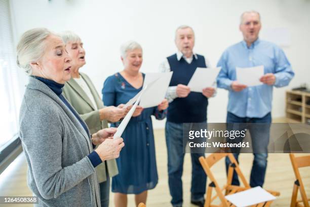 seniors in retirement home making music singing in choir - psalm bildbanksfoton och bilder
