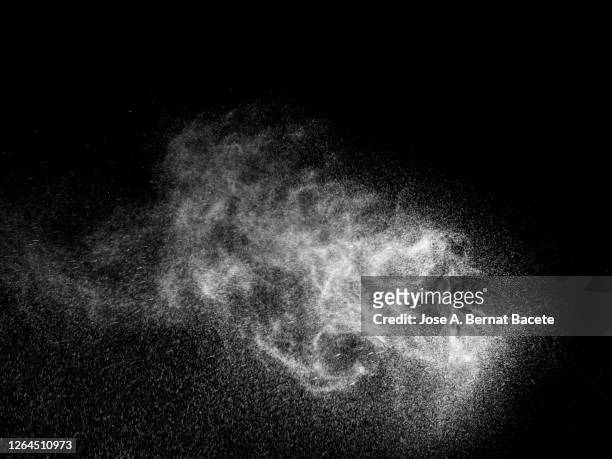 full frame of the textures formed  by the water jets to pressure with drops floating in the air on a black background - spray stock pictures, royalty-free photos & images