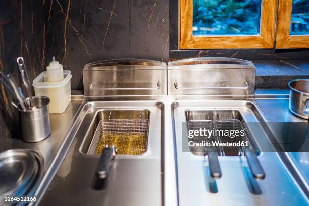 deep fryer in restaurant kitchen - freidora fotografías e imágenes de stock