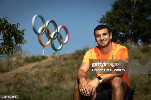 Athlete Adam Gemili poses for a photograph in front of the Olympic Rings as he takes part in an Alzheimer's Society memory walk, to honour his...