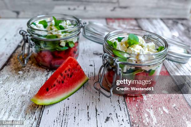 watermelon slice and jars of watermelon salad with feta cheese, corn salad and mint - mache stock pictures, royalty-free photos & images