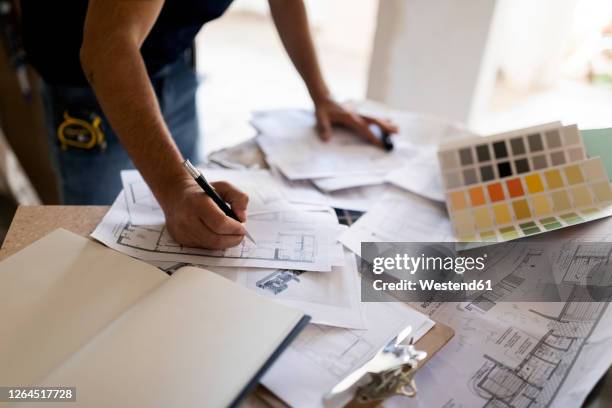 man working on construction plan and colour swatch - floor plan stock pictures, royalty-free photos & images