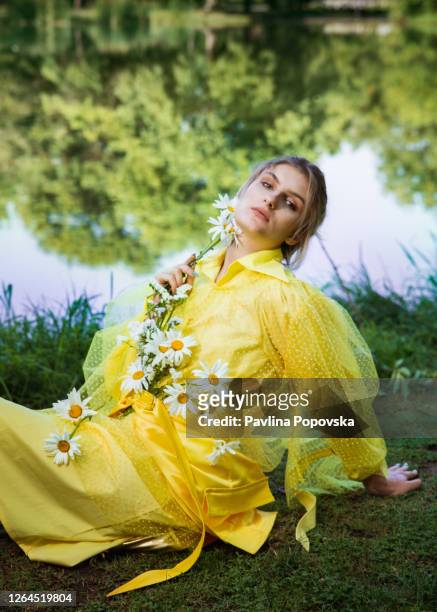 portrait of a woman with flowers - editorial woman stock pictures, royalty-free photos & images