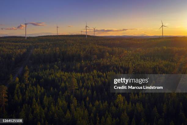 wind power stations in a forest landscape - dalarna stock pictures, royalty-free photos & images