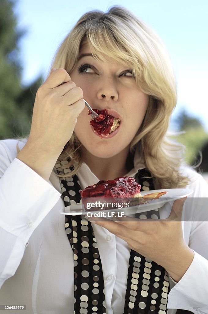 Close-up of woman eating cake