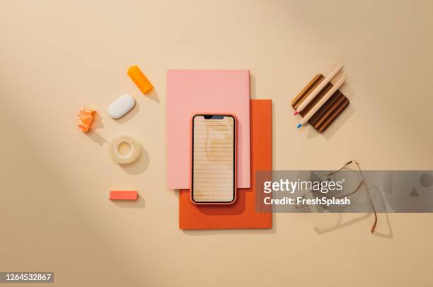 back to school: a neat flat lay minimalistic still life composition of school supplies (books, sticky notes, pens, technology) - still life not people imagens e fotografias de stock