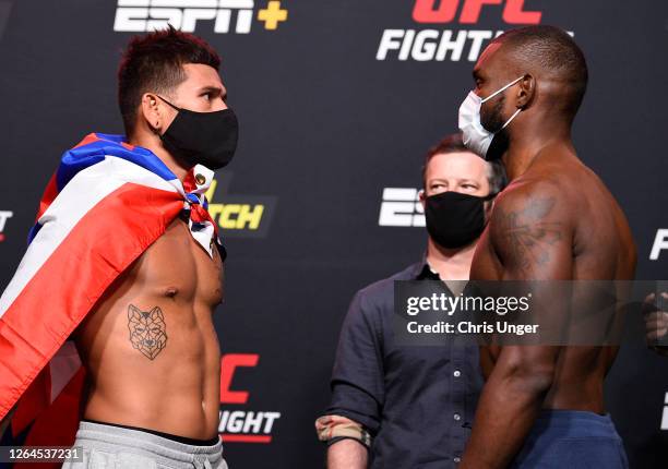 Opponents Maki Pitolo and Darren Stewart of England face off during the UFC Fight Night weigh-in at UFC APEX on August 07, 2020 in Las Vegas, Nevada.