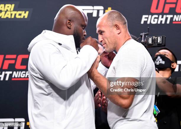 Opponents Derrick Lewis and Aleksei Oleinik of Russia face off during the UFC Fight Night weigh-in at UFC APEX on August 07, 2020 in Las Vegas,...