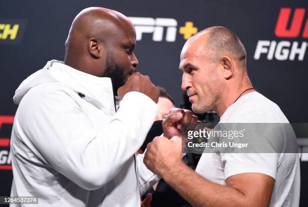 Opponents Derrick Lewis and Aleksei Oleinik of Russia face off during the UFC Fight Night weigh-in at UFC APEX on August 07, 2020 in Las Vegas,...
