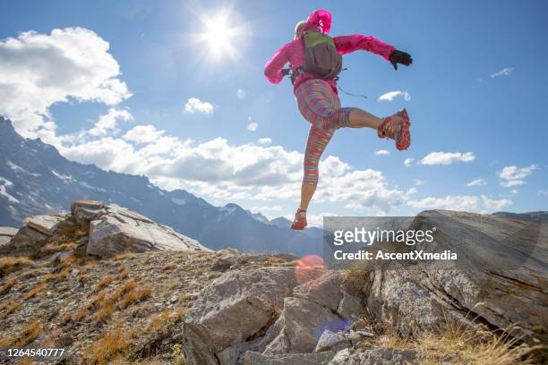 trail runner ascends high mountain ridge - leap forward stock pictures, royalty-free photos & images
