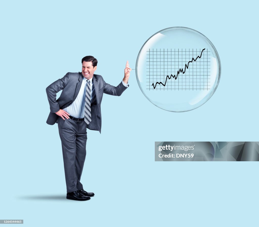 Businessman Popping The Stock Market Bubble