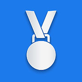 Paper cut Medal icon isolated on blue background. Winner symbol. Paper art style. Vector Illustration