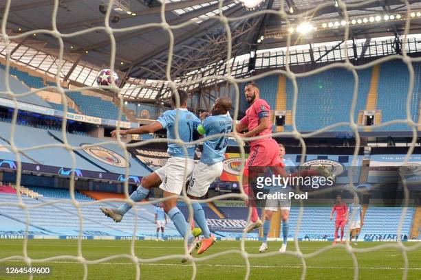 Karim Benzema of Real Madrid scores his team's first goal during the UEFA Champions League round of 16 second leg match between Manchester City and...