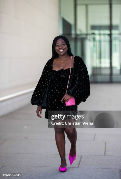 Lois Opoku is seen wearing black dress with dots prints and wide sleeves The Attico, purple Balenciaga heels, pink Chanel bag, Ariane Ernst necklace...