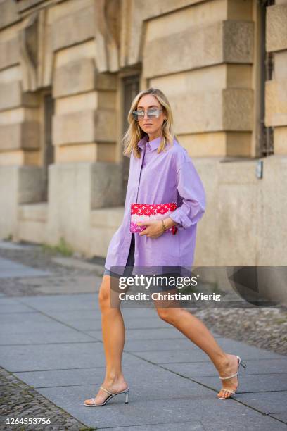 Sonia Lyson is seen wearing Jimmy Choo heels, sun darby cylce pants, Louis Vuitton bag, button shirt Edited, sunglasses Fendi on August 07, 2020 in...