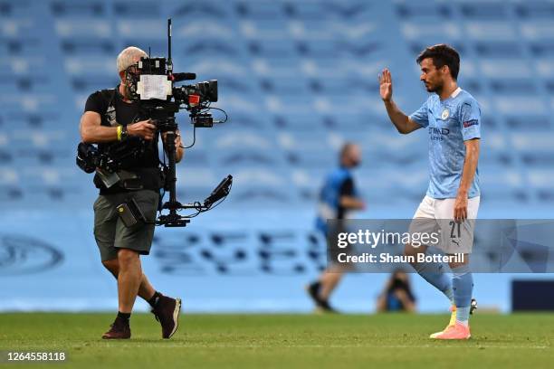 David Silva of Manchester City acknowledges the TV Camera following the UEFA Champions League round of 16 second leg match between Manchester City...
