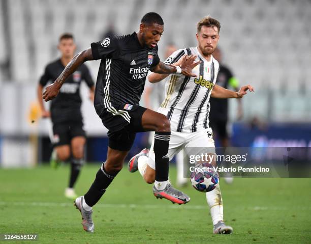 Jeff Reine-Adelaide of Olympique Lyon is challenged by Aaron Ramsey of Juventus during the UEFA Champions League round of 16 second leg match between...