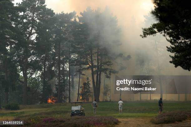 General view as course staff work to stop a fire which spread from Cobham heath over to the 9th and 10th holes as smoke is seen covering the course...