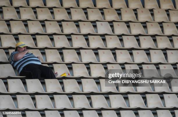 New Zealand cricket fan relaxes as he watches the match from the gallery during the first day of the second Test match at the McLean Park in Napier...