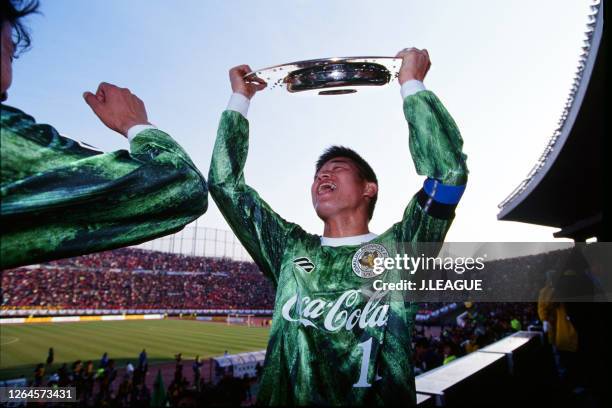 Captain Kazuyoshi Miura of Verdy Kawasaki lifts the trophy at the award ceremony as his side's celebrate the season champions following the J.League...