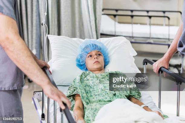 boy in children's hospital being moved on gurney - pushing stretcher stock pictures, royalty-free photos & images
