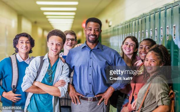 teacher and high school students hanging out in hallway - school principal stock pictures, royalty-free photos & images