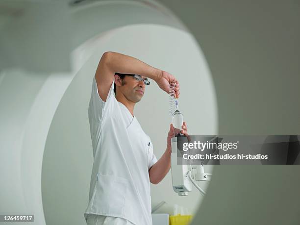 nurse adjusting x-ray machine - fluoroskop bildbanksfoton och bilder