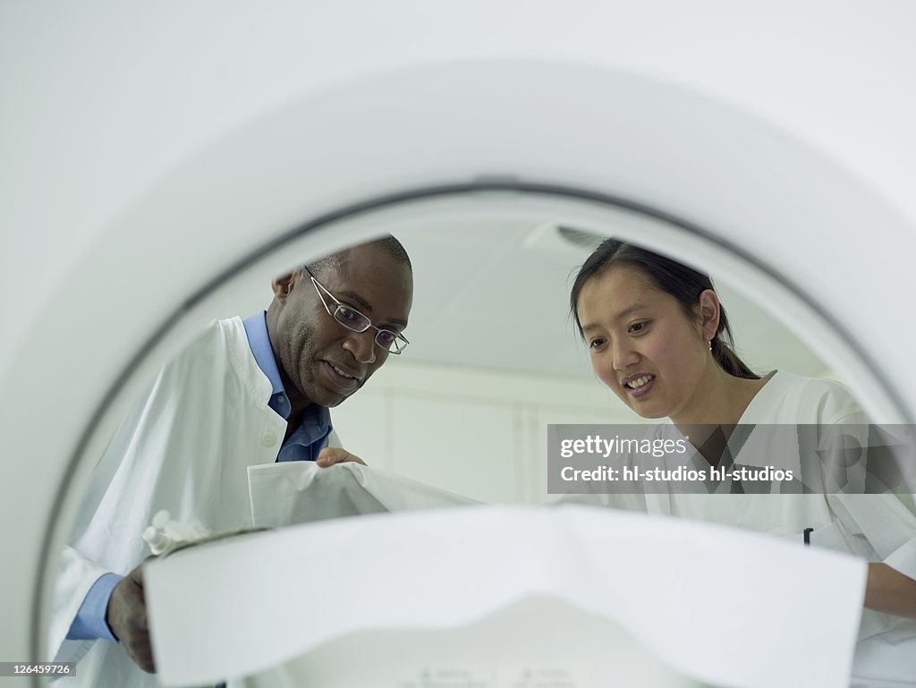 Doctors checking patient before MRI scan