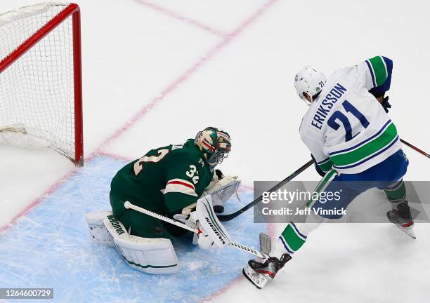 Alex Stalock of the Minnesota Wild stops a shot by Loui Eriksson of the Vancouver Canucks during the second period in Game Four of the Western...