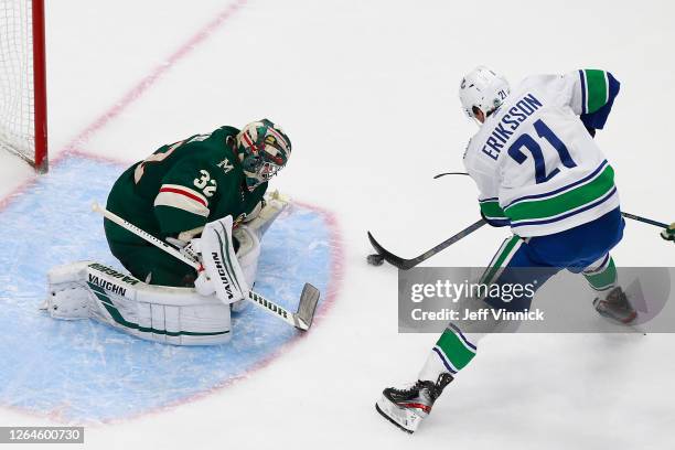 Alex Stalock of the Minnesota Wild stops a shot by Loui Eriksson of the Vancouver Canucks during the second period in Game Four of the Western...