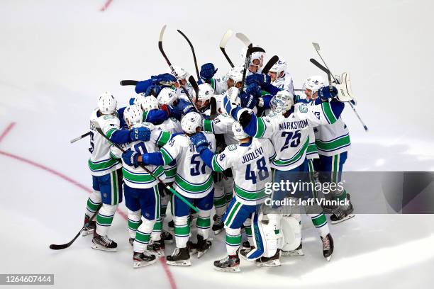 The Vancouver Canucks celebrate their 5-4 win on a goal by Christopher Tanev at :11 in overtime to defeat the Minnesota Wild in Game Four and the...