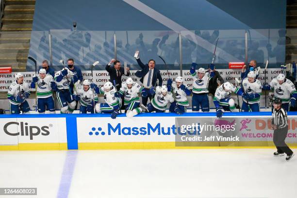 The Vancouver Canucks celebrate their 5-4 win on a goal by Christopher Tanev , at :11 in overtime to defeat the Minnesota Wild in Game Four and the...