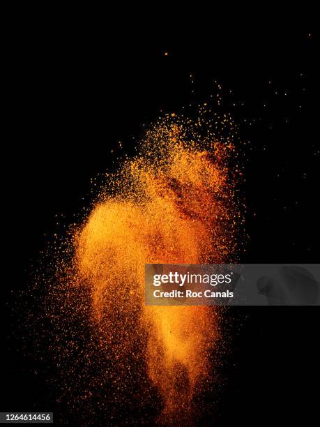 powder explosion - orange powder stock pictures, royalty-free photos & images