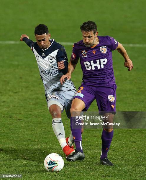 Birkan Kirdar of the Victory pressures Vince Lia of the Glory during the round 25 A-League match between the Perth Glory and the Melbourne Victory at...